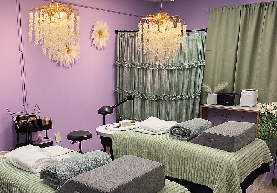 The sage and lavender treatment room with chandelier and spa beds